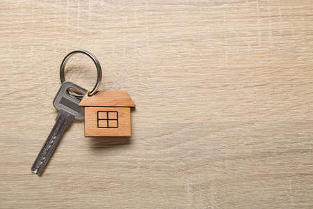 House key with keychain on wooden backgroundの写真素材
