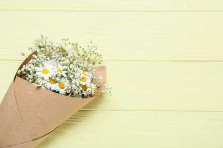 Bouquet of beautiful chamomile flowers on color wooden backgroundの写真素材