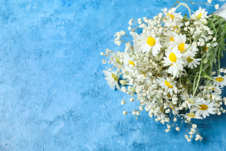 Bouquet of beautiful chamomile flowers on color backgroundの写真素材
