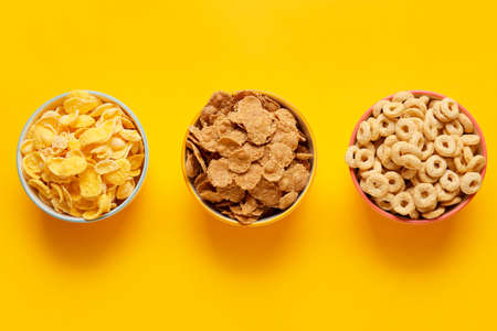 Bowls with different cereals on color backgroundの写真素材