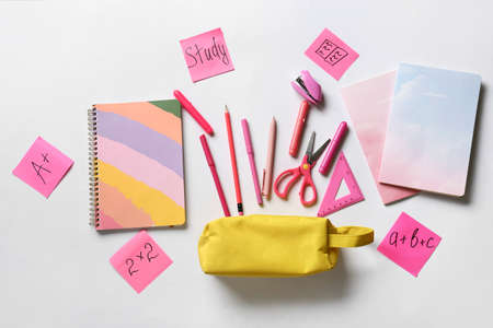 Pencil case with stationery on white background