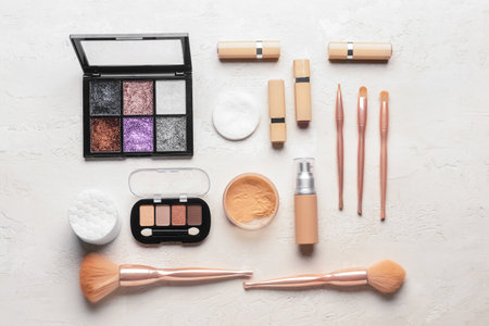 Decorative cosmetics, brushes and soft cotton pads on light backgroundの写真素材