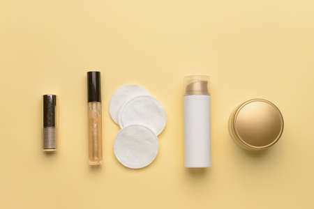 Clean cotton pads, decorative and care cosmetics on color backgroundの写真素材