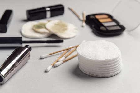 Various cosmetics, cotton buds and cotton pads on gray table, closeupの写真素材