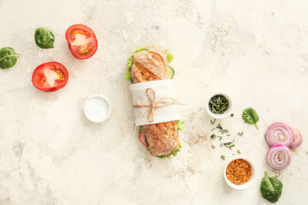 Tasty ciabatta sandwich on light background