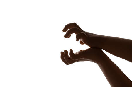 Child performing a shadow play on white backgroundの写真素材