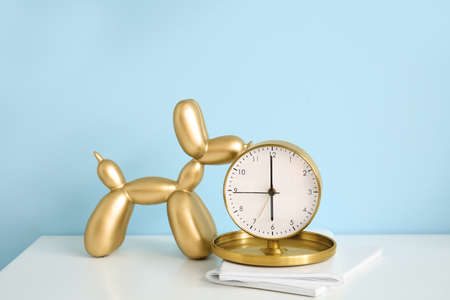 Alarm clock and decor on table near color wall, closeupの写真素材