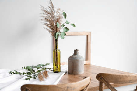 Beautiful flower dried bouquet in bottle on wooden table