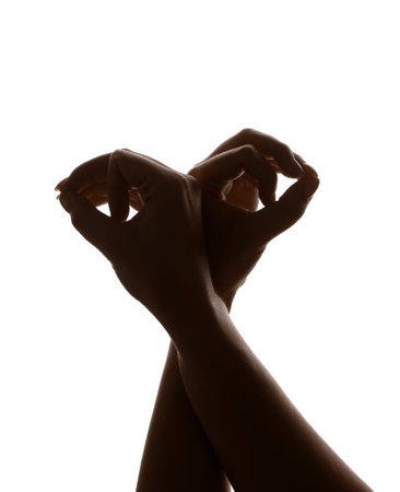 Woman performing a shadow play on white backgroundの写真素材