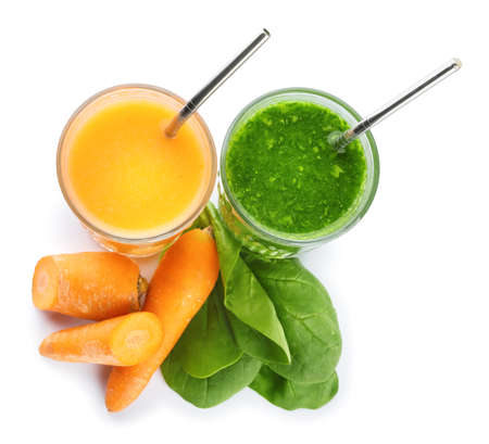 Glasses of healthy carrot and spinach smoothie on white backgroundの写真素材