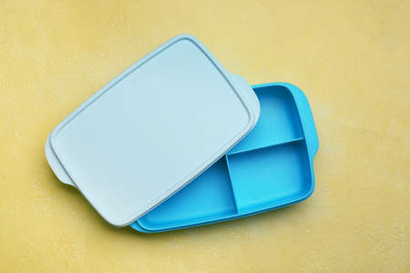 Empty school lunch box on color background