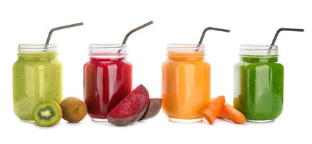 Mason jars of healthy smoothie with fruits and vegetables on white backgroundの写真素材