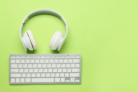 Headphones and keyboards on green backgroundの写真素材