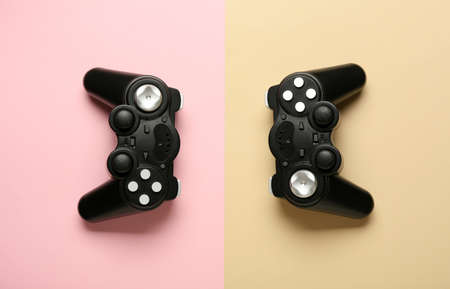 Modern joysticks on color background