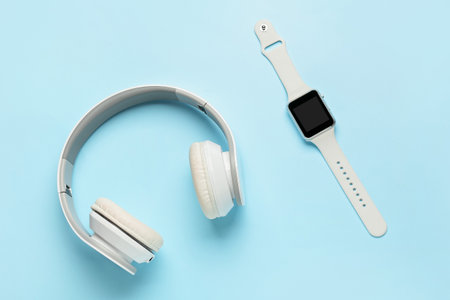 Headphones and smart watch on color backgroundの写真素材