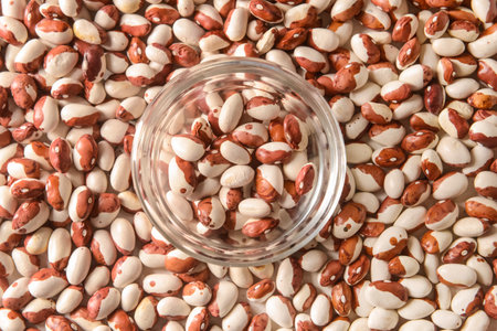 Glass bowl on raw beans, closeupの写真素材