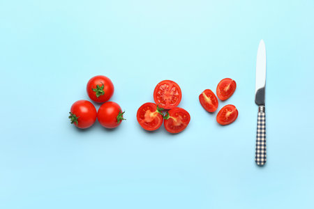 Fresh ripe tomatoes and knife on color backgroundの写真素材