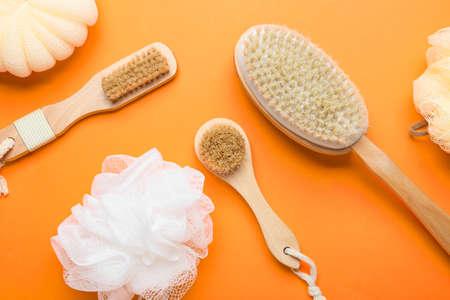 Massage brushes and sponges on color backgroundの写真素材