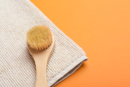 Massage brush and towel on color backgroundの写真素材