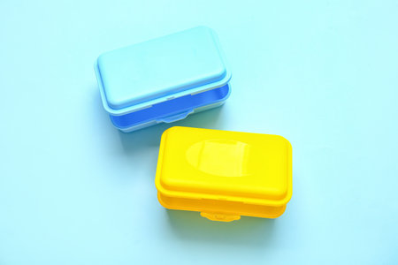 Plastic lunch boxes on color background