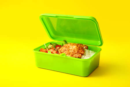 Lunch box with tasty food on color backgroundの写真素材