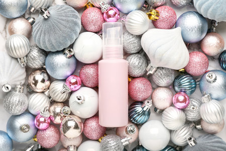 Cosmetic bottle on Christmas balls backgroundの写真素材