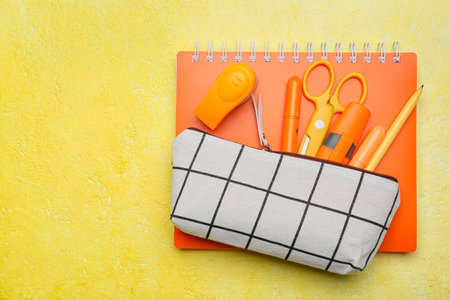 Pencil case and stationery on color background
