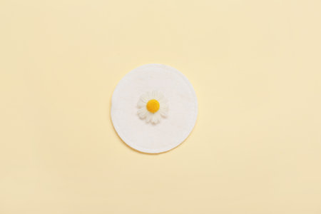 Clean cotton pad and flower on color backgroundの写真素材