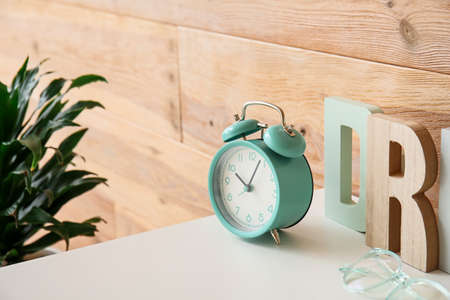 Stylish clock on table with decorの写真素材