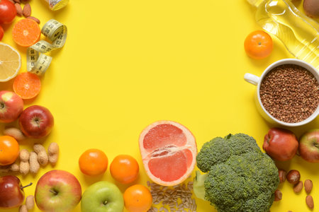 Different healthy products and measuring tape on yellow backgroundの写真素材