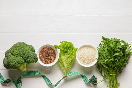 Composition with healthy products and measuring tape on light wooden backgroundの写真素材