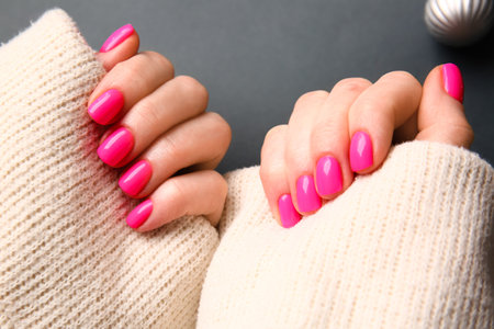 Woman with beautiful manicure on dark background, closeupの写真素材
