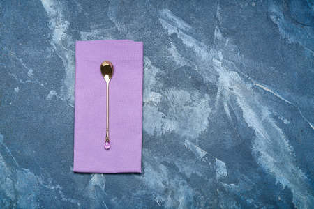 Spoon with napkin on color backgroundの写真素材