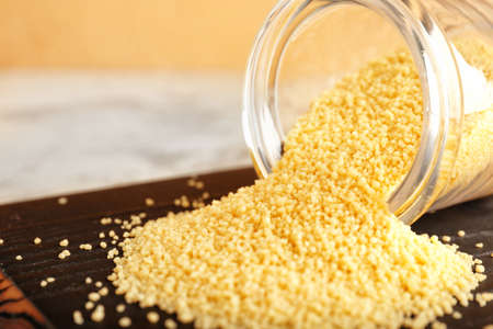 Jar with raw couscous on table, closeupの写真素材