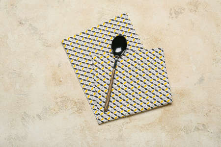 Spoon with napkin on grunge backgroundの写真素材
