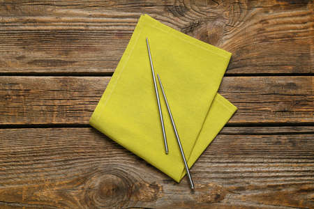 Chopsticks with clean napkin on wooden backgroundの写真素材