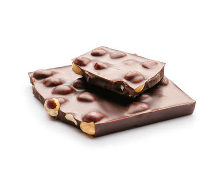 Pieces of tasty chocolate with hazelnuts on white background