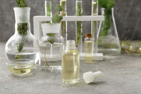 Bottle of natural essential oil on grunge background