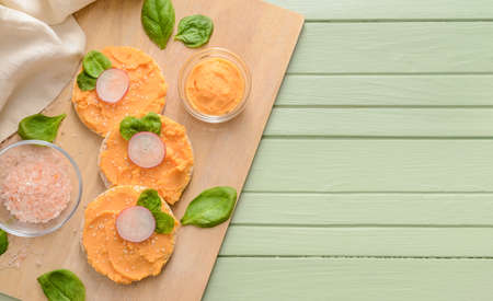Crispbreads with tasty hummus and salt on table