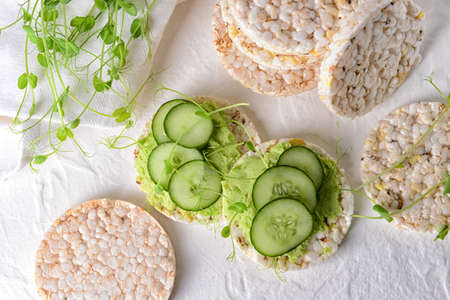 Crispbreads with tasty pea hummus on white backgroundの写真素材