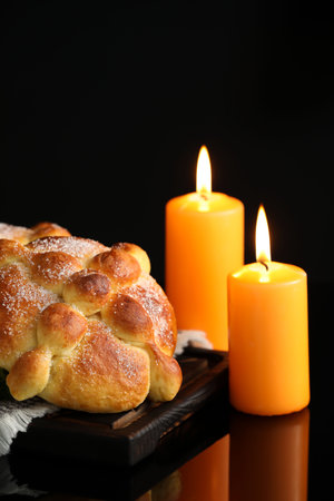 Bread of the dead and candles on dark background. Celebration of Mexico's Day of the Dead (El Dia de Muertos)の写真素材