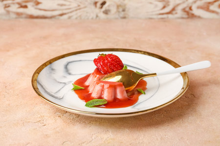 Tasty homemade strawberry panna cotta with mint in plate on color backgroundの写真素材