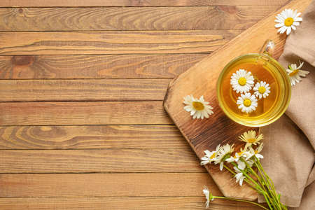 Cup with tasty floral tea on wooden backgroundの写真素材