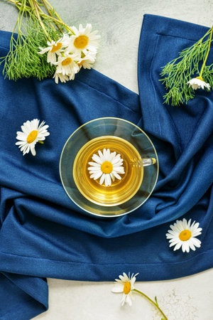 Cup with tasty floral tea on color backgroundの写真素材