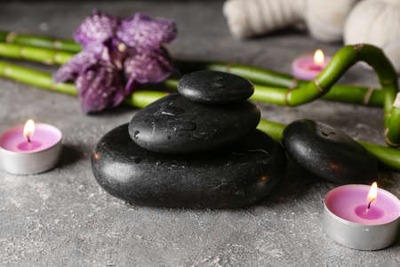 Spa stones with aroma candles on grunge backgroundの写真素材