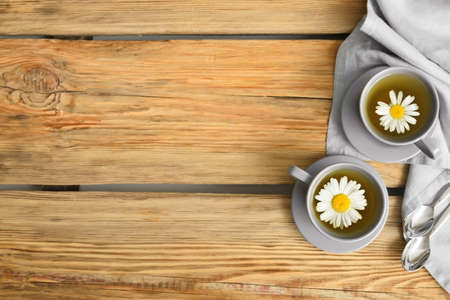 Cups with tasty floral tea on wooden backgroundの写真素材