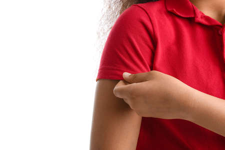 Cute African-American schoolgirl on white background, closeup