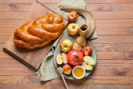 Honey with fruits, shofar and challah on wooden background. Rosh hashanah (Jewish New Year) celebrationの写真素材