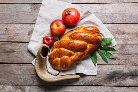 Shofar with fruits and challah on wooden background. Rosh hashanah (Jewish New Year) celebrationの写真素材