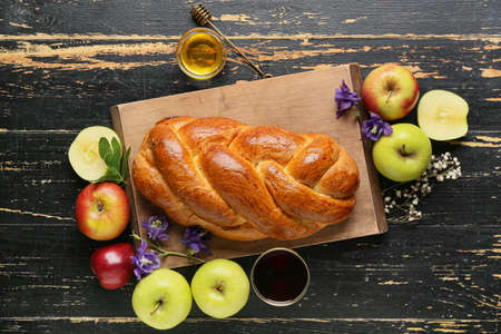 Honey with apples and challah on dark wooden background. Rosh hashanah (Jewish New Year) celebrationの写真素材